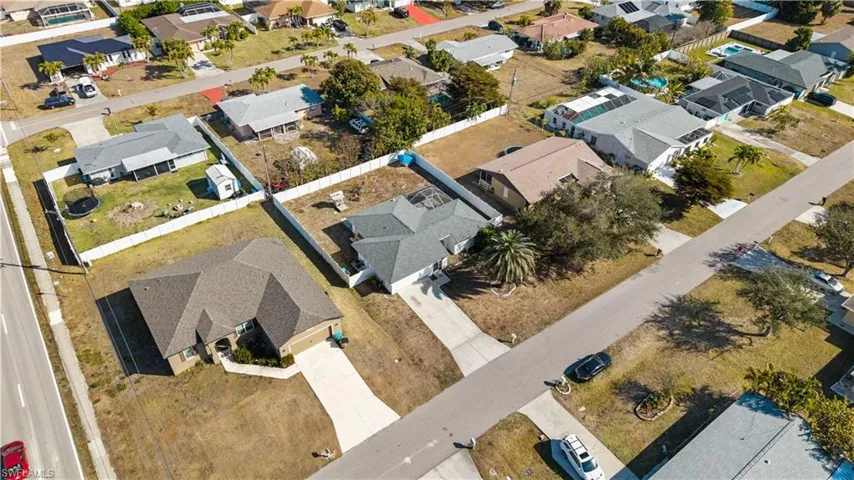 Aerial view of property's location with nearby suburban area