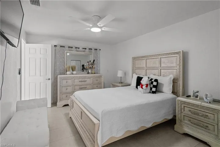 Bedroom featuring light tile patterned flooring and a ceiling fan