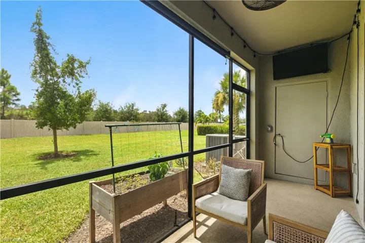 Screened lanai overlooking a peaceful green space—ideal for relaxing, dining, or enjoying Florida outdoor living.