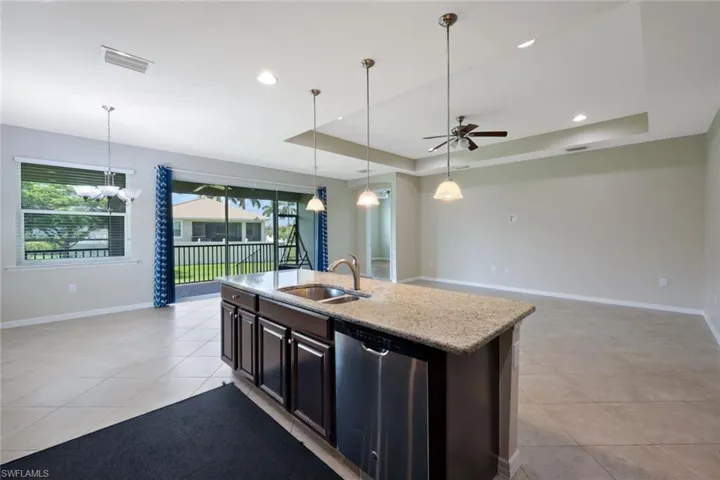 Kitchen island with a built-in sink and stainless steel dishwasher