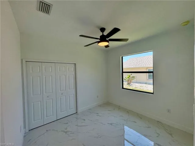 Unfurnished bedroom featuring tile floors, a closet, and ceiling fan