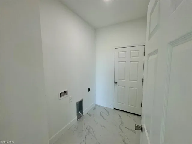 Clothes washing area featuring tile floors, washer hookup, and electric dryer hookup