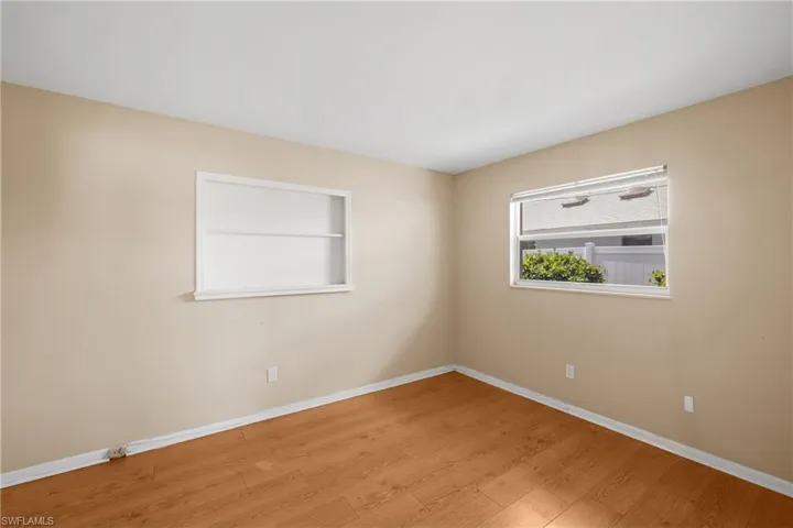 Unfurnished room featuring wood-type flooring