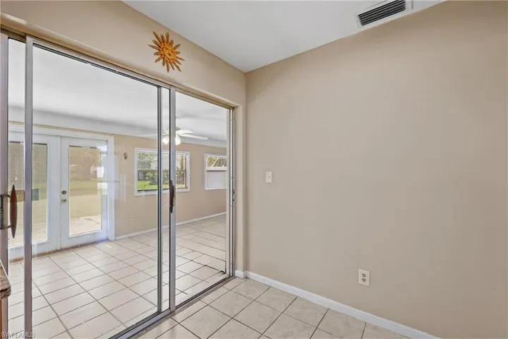 Doorway to outside with ceiling fan, french doors, and light tile flooring