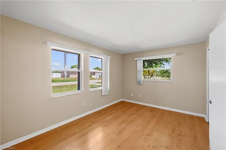 Empty room with a healthy amount of sunlight and light wood-type flooring