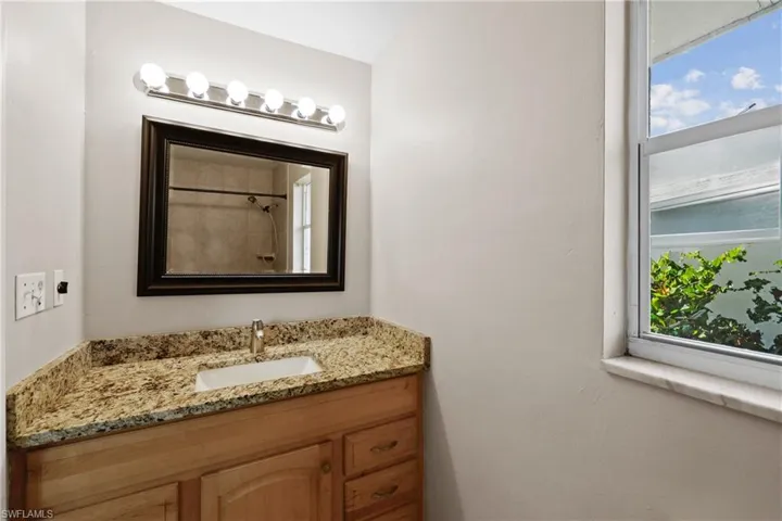 Bathroom featuring a healthy amount of sunlight and vanity