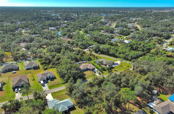 Aerial view of property's location featuring nearby suburban area