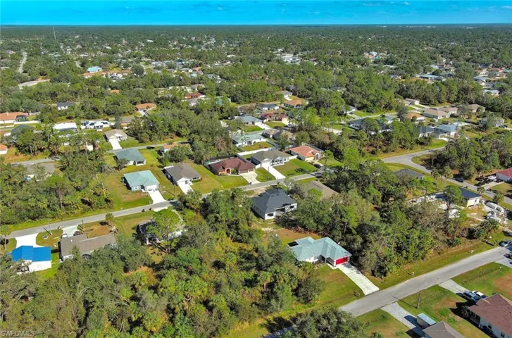 Aerial view of property's location featuring nearby suburban area