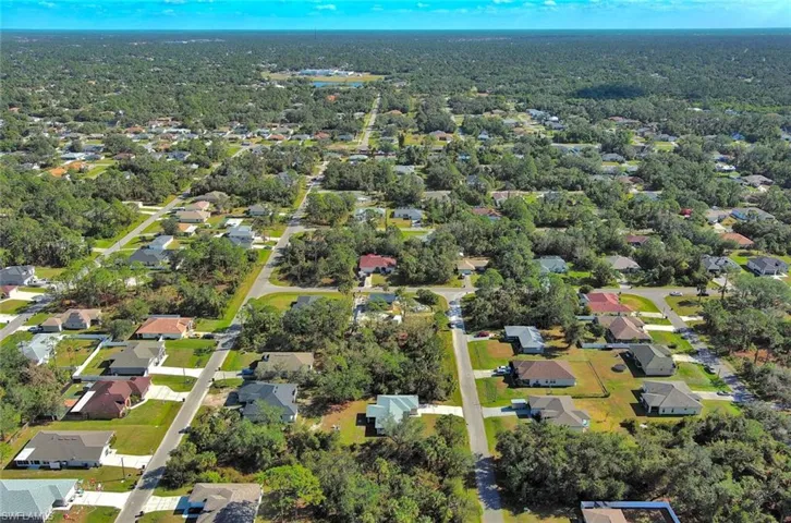 Aerial view of property's location featuring nearby suburban area