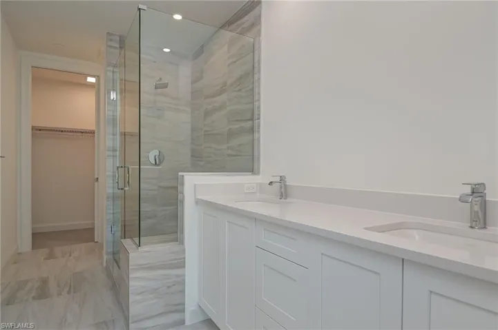 2nd bedroom ensuite with large closet, walk0in shower, and double vanity