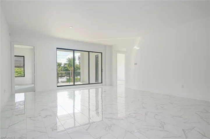 Palms and greenery outside - light and bright inside with impact sliders and access to balcony from both bedrooms as well as living area