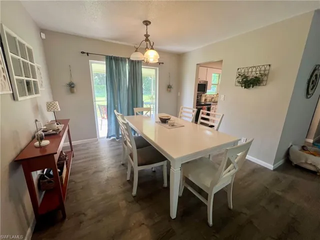 Dining room featuring LVP wood-style flooring and a textured ceiling
