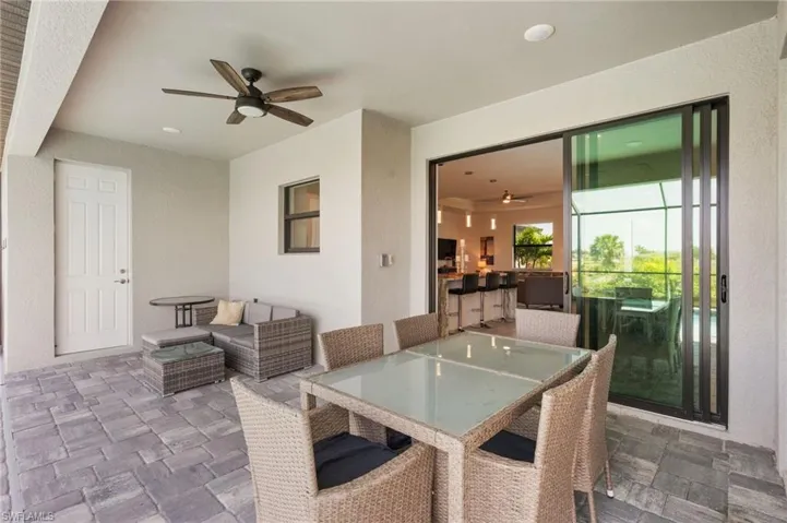 View of patio / terrace with an outdoor living space, outdoor dining area, and a ceiling fan