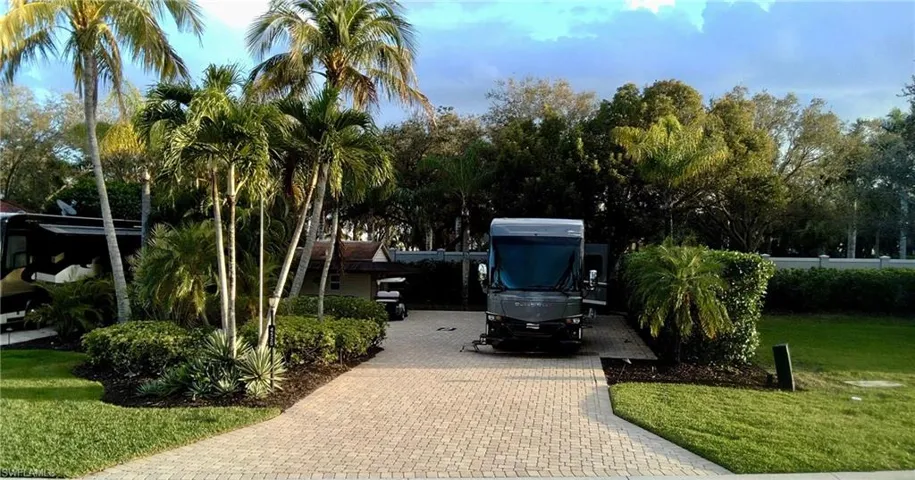 View of parking featuring decorative driveway