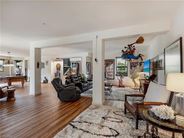 Living room with wood-type flooring and billiards