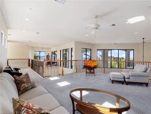 Living room featuring carpet flooring and ceiling fan