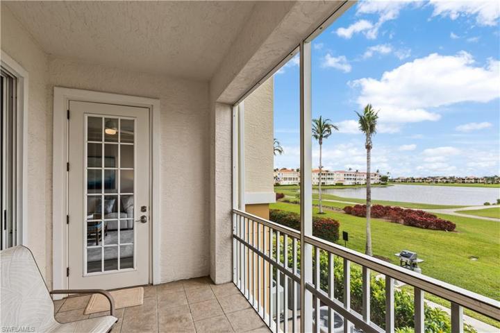 Patio w/ Panoramic views of the Lake, Golf Course and Sunsets. Patio access from Master Ensuite and Living Area. Walkway to Community Pool & Spa and Outside Grill adjacent to Golf Course. 2nd Grill just outside of Garages!