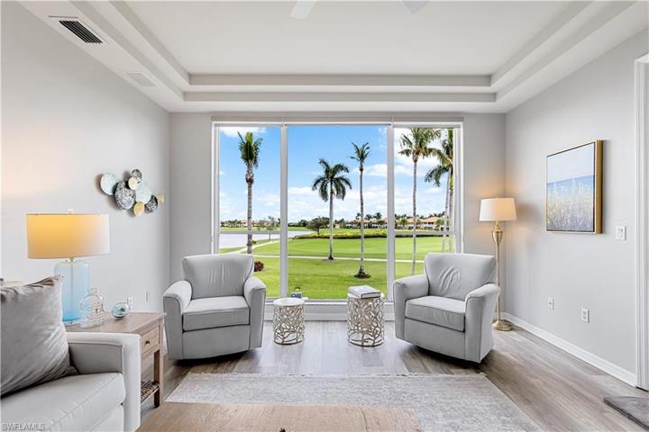 Living Area with LVP, Trey Ceiling and Entry Way To Lanai! Coastal Decor Throughout.