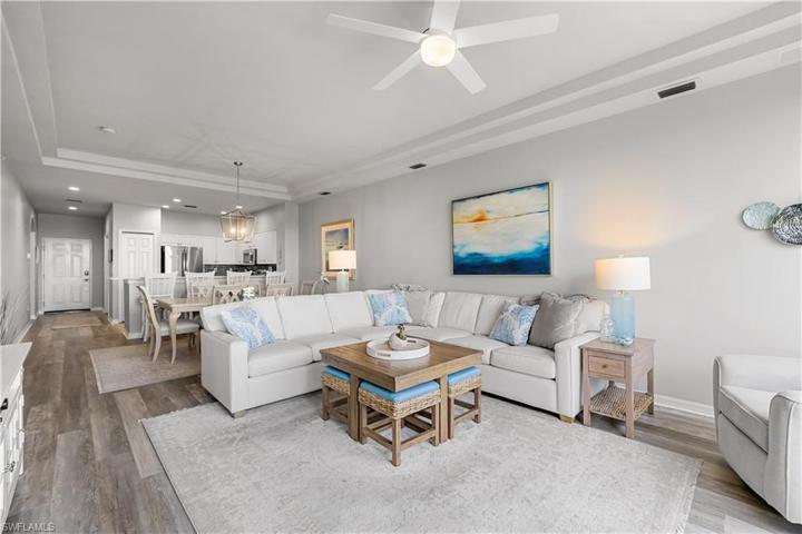 Dining and Living Area with LVP throughout living areas. Coastal decor and Trey Ceiling.