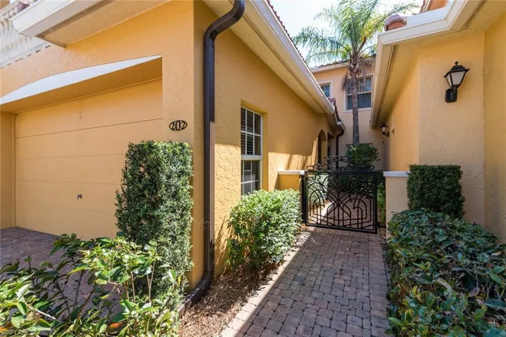 View of home's exterior with a gate and stucco siding