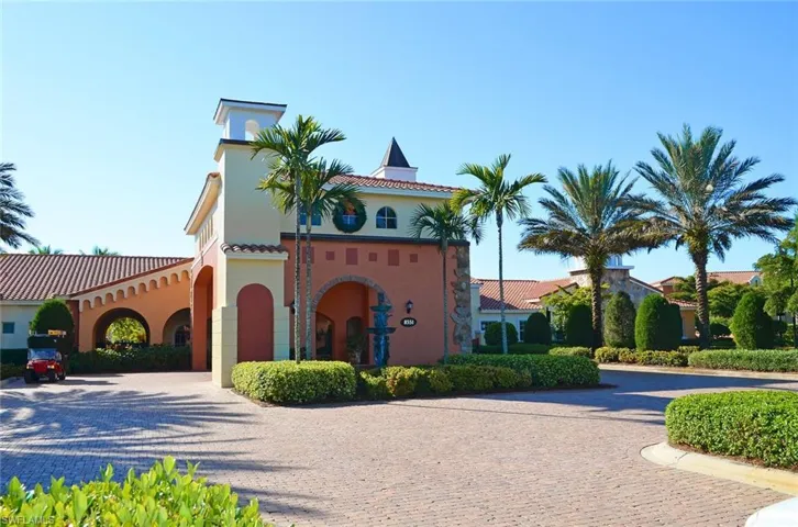 View of front facade featuring decorative driveway, a tile roof, and stucco siding