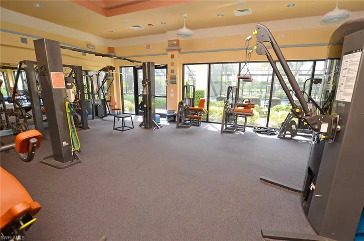 Workout area with ornamental molding and visible vents