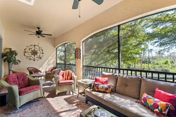 Sunroom / solarium featuring ceiling fan