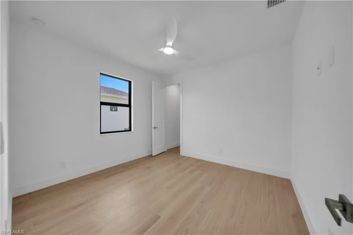 Bathroom with a shower stall, vanity, and wood finished floors