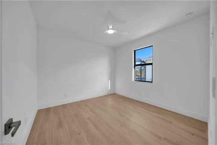 Full bath featuring wood finished floors, walk in shower, vanity, and recessed lighting