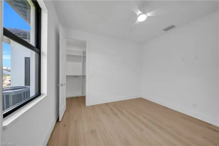 Spacious closet with wood finished floors