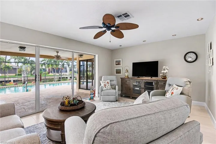 Living area featuring ceiling fan, a sunroom, and recessed lighting
