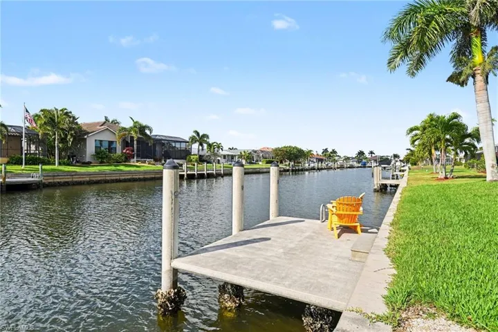 Dock area with a water view and a residential view