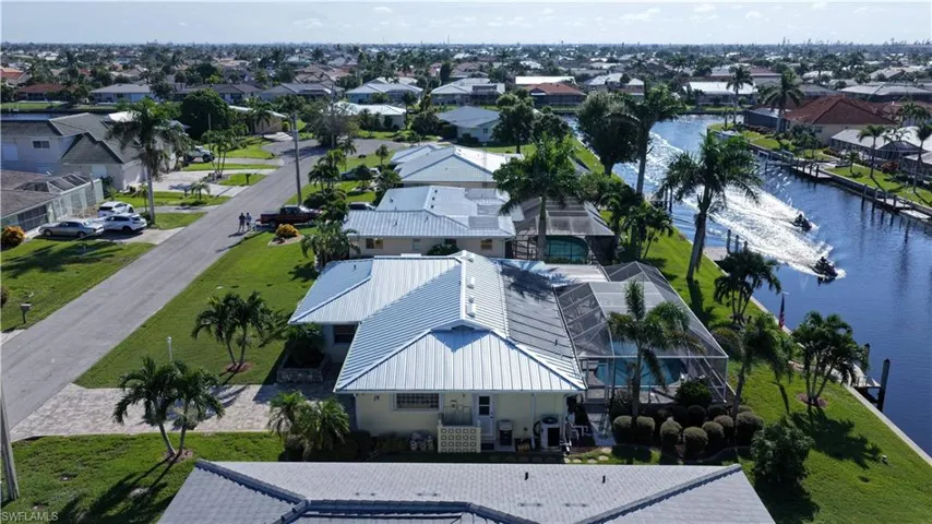 Aerial perspective of suburban area featuring a nearby body of water