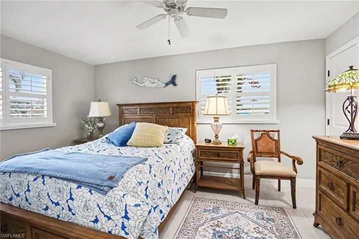 Bedroom with ceiling fan and light wood-style flooring
