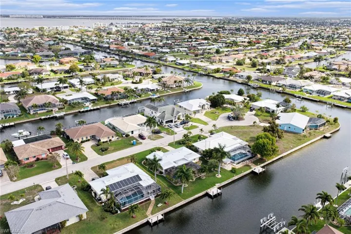 Aerial view of residential area featuring a nearby body of water