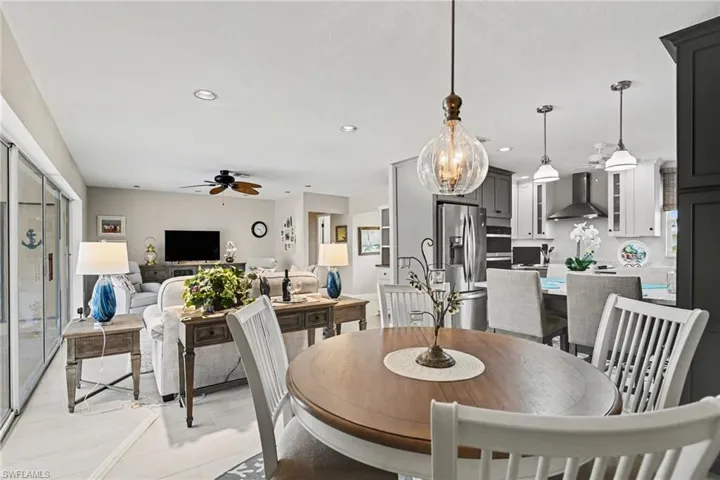Dining space featuring suspended lighting and ceiling fan