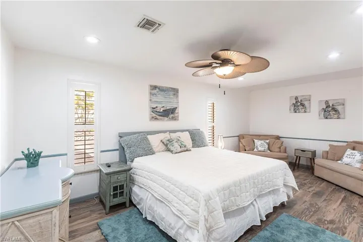 Bedroom with wood finished floors, recessed lighting, and a ceiling fan