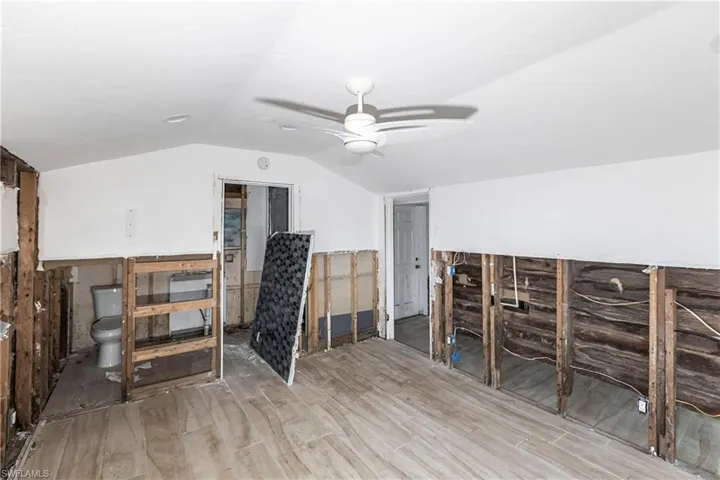 Bonus room featuring a ceiling fan, wood finished floors, and lofted ceiling