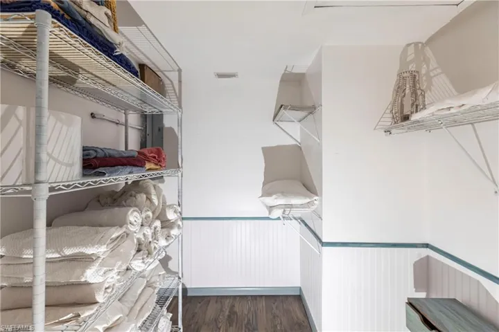 Walk in closet with wood finished floors