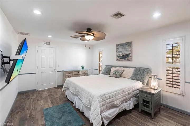 Bedroom with wood finished floors, recessed lighting, and a ceiling fan
