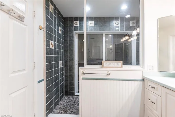 Full bath with vanity and a shower stall