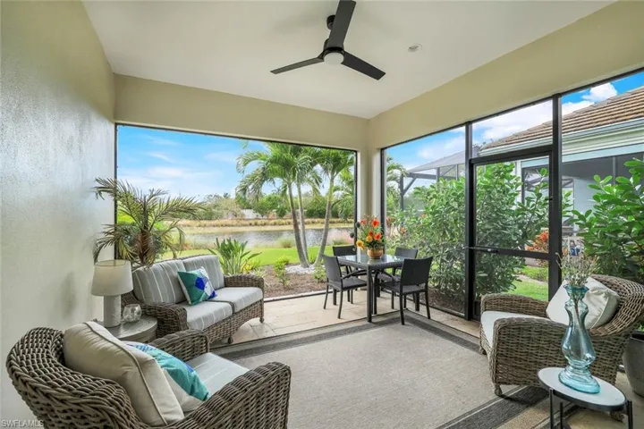 Sunroom with a water view and ceiling fan