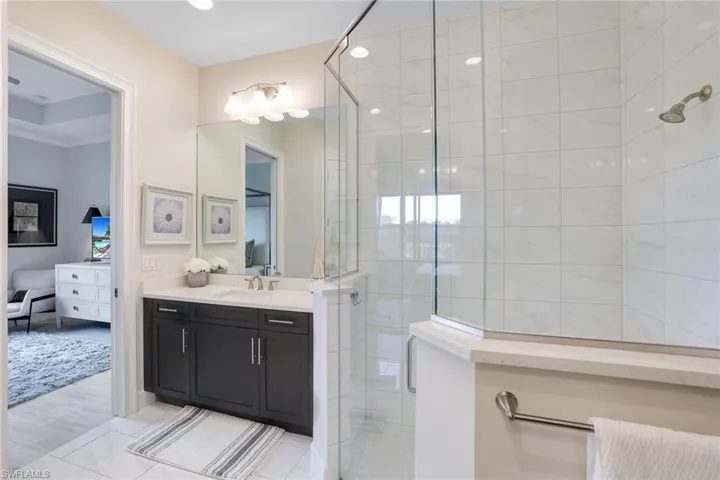 Bathroom with hardwood / wood-style floors, vanity, and a shower with door