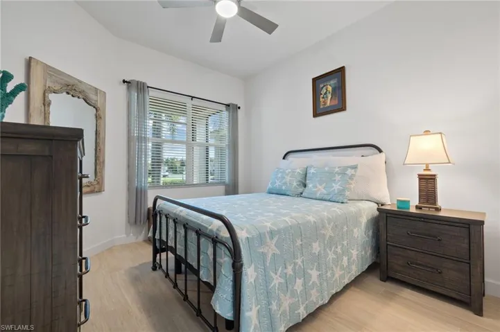 This guest bedroom is light and airy! It has (upgraded from original carpeting)LVT flooring, and a ceiling fan. Floor plan features the 2nd bath directly opposite this bedroom.