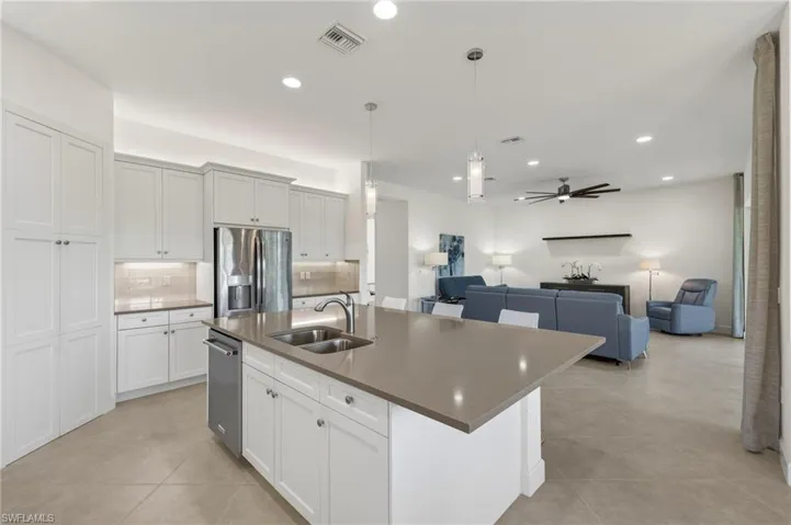 Kitchen features upgraded pantry doors to match cabinets, a new dishwasher in '24, and plenty of cupboard and counter space for a cook's dream!