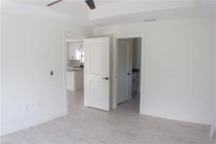 Bright interior with light wood-finish flooring and crisp white walls