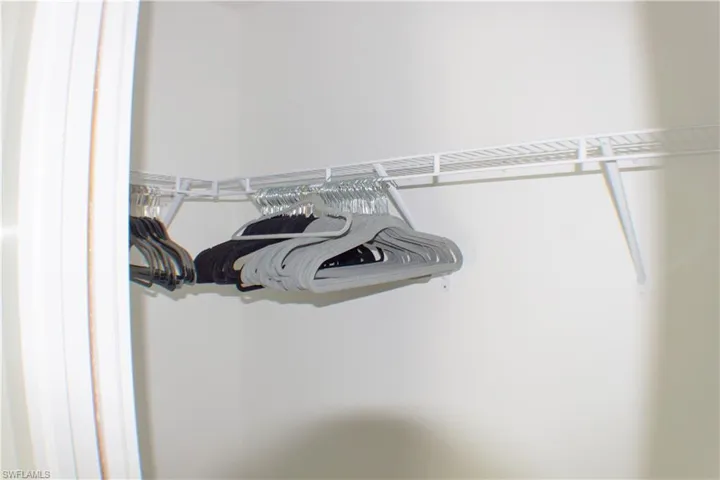 Closet with white wire shelving and hanging rods