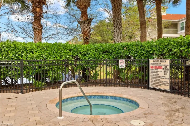 View of pool with a community hot tub