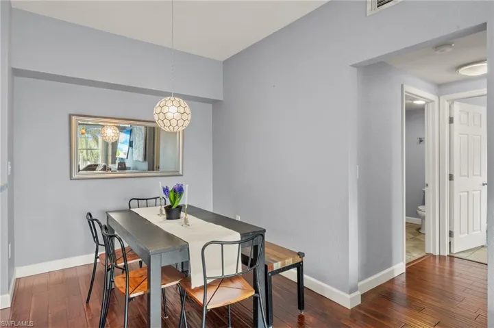 Dining space featuring wood-type flooring and baseboards