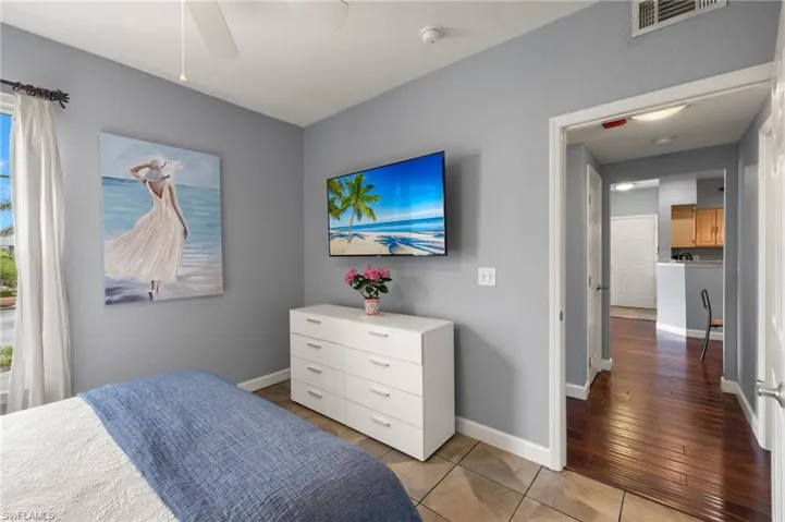 Bedroom with light tile patterned floors and a ceiling fan